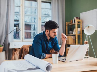 Architect working on a laptop at his office.